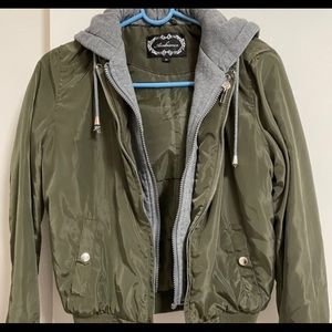 Green windbreaker with grey sweater